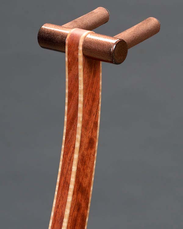 Bubinga with curly maple edge binding. Copper powdercoating.